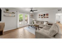Bright living room with hardwood floors, stylish decor, and French doors leading to balcony at 603 Brighton Pt, Atlanta, GA 30328