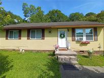 Charming single-story home with a welcoming front entrance and cheerful yellow siding at 649 Mary Ln, Marietta, GA 30062