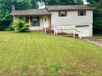 Two-story home with a traditional design, featuring a one-car garage and front yard, with a grass lawn at 718 Hardy Way, Hiram, GA 30141