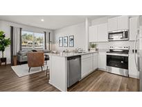 Modern kitchen featuring white cabinets, stainless steel appliances, and granite countertops at 2810 Georgia Aster Nw Way # 6, Atlanta, GA 30318
