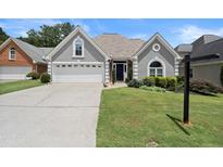 Charming one-story home with a well-manicured lawn, a two-car garage, and a welcoming front entrance at 170 Shelli Ln, Roswell, GA 30075