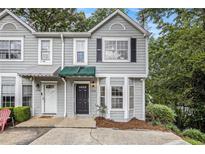 Charming townhome featuring a gray exterior, covered entry, and well-maintained landscaping at 4098 Charlotte Se Ct, Smyrna, GA 30082