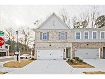Charming new construction townhome featuring a two-car garage and brick accents at 699 Sunstone Ln, Lawrenceville, GA 30043
