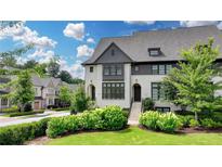 Beautiful exterior of this new construction, white painted brick townhouse with black trim and well landscaped lawn at 6399 Lucent Ln, Atlanta, GA 30328