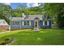 Charming blue two-story home with dormer windows and a well-maintained lawn and mature trees at 1046 S Mcdonough St, Decatur, GA 30030