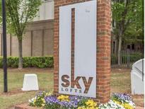 Attractive sign for Sky Lofts is surrounded by colorful flowers at 898 Oak St Sw # 1215, Atlanta, GA 30310