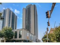 Exterior view of a high-rise condominium building showcasing its architectural design and the surrounding urban landscape at 1280 W Peachtree Street Nw # 808, Atlanta, GA 30309
