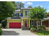 Charming two-story home featuring a red garage door, red front door, and manicured landscaping at 2822 Prado Ln, Marietta, GA 30066