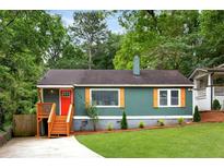 Charming single-story home with a well-manicured lawn, inviting porch and colorful door at 1258 Campbellton Sw Rd, Atlanta, GA 30310