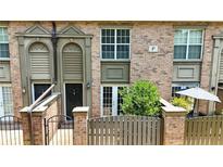 Charming brick townhouse with a small fenced-in patio and covered front entryways at 6980 Roswell Rd # P6, Atlanta, GA 30328