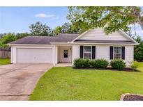 Charming home with a manicured lawn, attached garage, and welcoming front entrance at 102 Natalie Ct, Dallas, GA 30157