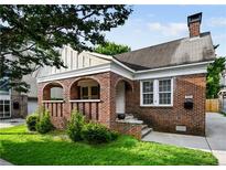 Charming brick home with a cozy front porch and well-maintained lawn at 563 Ralph Mcgill Ne Blvd, Atlanta, GA 30312