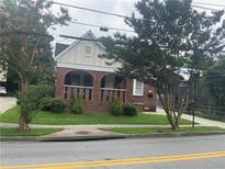 Charming brick home with a manicured lawn and quaint architectural details at 563 Ralph Mcgill Ne Blvd, Atlanta, GA 30312