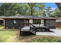 Charming renovated home with modern exterior, featuring a painted brick facade, new porch and stylish black and white accents at 1853 Pinedale Pl, Decatur, GA 30032
