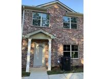 Charming brick two-story home featuring a covered entrance and multiple windows at 3413 Mount Zion Rd, Stockbridge, GA 30281