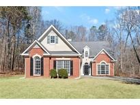 Charming brick and siding home with well-maintained lawn, mature trees, and a welcoming facade at 4021 Melvin Sw Dr, Atlanta, GA 30331