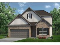 Charming two-story home boasts a brick facade, grey garage door, and a manicured lawn, perfect for suburban living at 847 Kensington St, Kingston, GA 30145