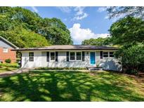 Charming ranch-style house with a well-manicured lawn and a bright blue front door at 123 Arnold Pl, Jonesboro, GA 30236