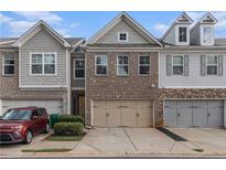 Charming townhomes with a brick and siding facade and attached two-car garages at 3931 Fireoak Dr, Decatur, GA 30032