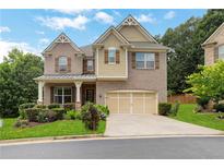 Charming two-story home with brick facade, well-manicured lawn, and attached two-car garage at 1105 Sterling Brooke Dr, Alpharetta, GA 30022
