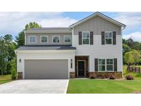 Charming two-story home with a gray two-car garage and a well-manicured front yard at 4563 Sweetlake Court Sw, Mableton, GA 30127