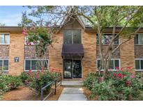 Attractive brick condo building exterior with stone accents and landscaping at 115 Biscayne Nw Dr # E3, Atlanta, GA 30309