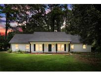 Charming single-story home with a well-maintained lawn, black shutters, and an inviting front porch at 2487 Highland Se Dr, Conyers, GA 30013