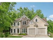 Charming two-story home with stone and stucco exterior and a well-manicured lawn at 3355 Golfe Links Dr, Snellville, GA 30039