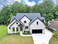 Stunning two-story home with a black trim and a manicured lawn, offering modern elegance at 3562 Clubland Dr, Marietta, GA 30068
