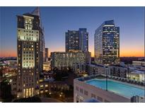 Stunning city view with pool and modern high rise buildings at dusk, perfect for urban living at 3324 Peachtree Ne Rd # 1604, Atlanta, GA 30326