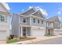 Charming two-story home with gray siding, stone accents, and a two-car garage at 4778 Moonstone Trce, Kennesaw, GA 30144