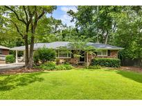Charming brick home with a well-maintained front yard and mature trees at 2163 Medfield Ne Trl, Chamblee, GA 30345