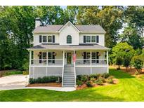 Charming two-story home featuring a spacious front porch, lush landscaping, and a welcoming curb appeal at 2401 Stockton Dr, Marietta, GA 30066