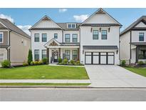 Charming two-story home with a well-manicured lawn and a classic white facade at 4189 Brookmont Way, Auburn, GA 30011