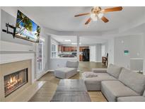 Open-concept living room featuring fireplace, modern furniture, and seamless flow to the kitchen at 4240 N Braves Cir, Douglasville, GA 30135
