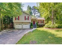 Charming home featuring a well-manicured lawn, two-car garage, and inviting front porch at 224 Amy Blvd, Temple, GA 30179
