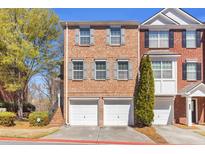 Attractive two-story brick townhome with two-car garage and manicured landscaping at 420 Heritage Park Nw Trce # 22, Kennesaw, GA 30144