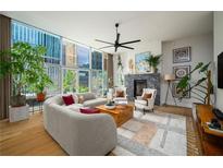 Bright living room featuring floor-to-ceiling windows and a modern fireplace with comfortable seating at 845 Spring Nw St # Ph4, Atlanta, GA 30308