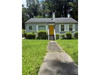 Charming single-story home with a yellow door, a well-manicured lawn and shrubbery at 247 Whitaker Nw Cir, Atlanta, GA 30314