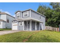 Charming two-story home features a covered front porch and attached garage, perfect for comfortable living at 4706 Cedar Park Trl, Stone Mountain, GA 30083