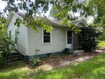 Cozy one-story home featuring light blue siding, a small porch, and a well-maintained yard at 2096 Boar Tusk Ne Rd, Conyers, GA 30012