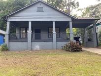 Charming single story home featuring a covered porch, front yard and convenient carport at 1053 Metropolitan Parkway Southwest Sw Pkwy, Atlanta, GA 30310