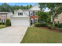 Charming two-story home featuring a well-manicured lawn and a two-car garage at 475 Chippenham Ct, Alpharetta, GA 30005