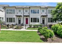 Charming townhome with red door, black awnings, and a beautifully manicured front yard at 1954 Summit Trace Circle Northwest, Atlanta, GA 30318