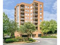Stunning brick condo building featuring multiple balconies and lush landscaping at 395 Central Park Ne Pl # 610, Atlanta, GA 30312
