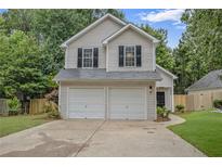 Charming two-story home featuring a two-car garage and well-maintained landscaping in a desirable location at 161 Stoneforest Dr, Woodstock, GA 30189