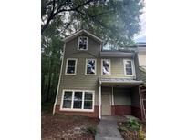 Charming two-story home with light green siding, brick accents, and large windows at 101 Dancing Fox Rd, Decatur, GA 30032