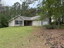 Charming single-story home with neutral siding, black shutters, and a well-maintained front lawn at 169 Rachel Blvd, Temple, GA 30179