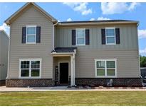 Charming two-story home with neutral siding, dark shutters, and a welcoming front porch at 15 Regal Ln, Covington, GA 30016