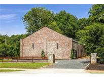 Unique brick building with professional landscaping and stylish stone and iron fence at 538 Main St, Palmetto, GA 30268